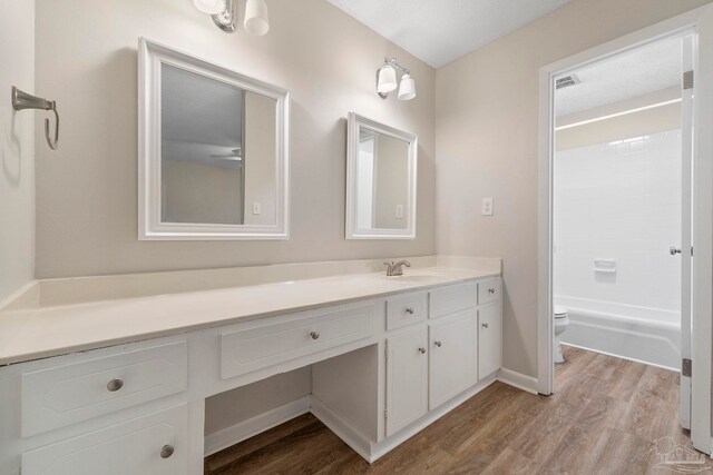 3481 Summit Blvd, Pensacola, FL 32503 - bathroom with vanity, toilet, wood finished floors, and shower / bathtub combination