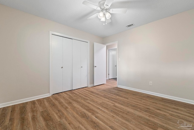 3481 Summit Blvd, Pensacola, FL 32503 - unfurnished bedroom featuring baseboards, wood finished floors, a closet, and ceiling fan