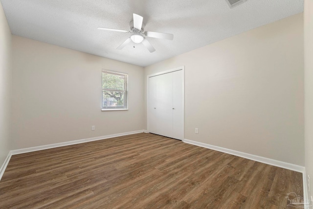 3481 Summit Blvd, Pensacola, FL 32503 - unfurnished bedroom with wood finished floors, a closet, baseboards, and a textured ceiling