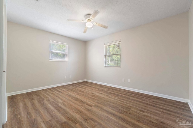 3481 Summit Blvd, Pensacola, FL 32503 - spare room featuring plenty of natural light, ceiling fan, wood finished floors, baseboards, and a textured ceiling