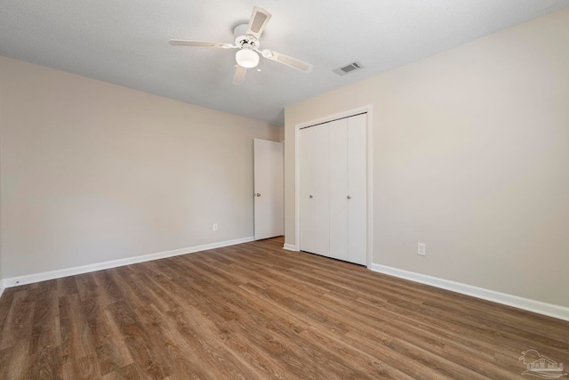 3481 Summit Blvd, Pensacola, FL 32503 - unfurnished bedroom featuring wood finished floors, baseboards, a closet, and a ceiling fan