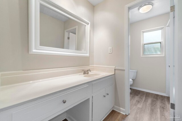 3481 Summit Blvd, Pensacola, FL 32503 - full bathroom featuring wood finished floors, toilet, vanity, and baseboards