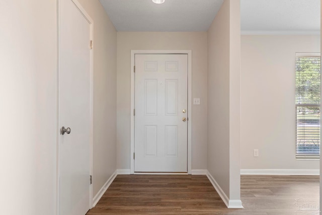 3481 Summit Blvd, Pensacola, FL 32503 - doorway with wood finished floors, baseboards, and crown molding
