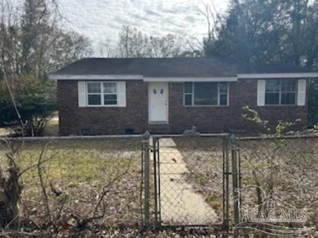 ranch-style house featuring a gate, brick siding, and fence private yard