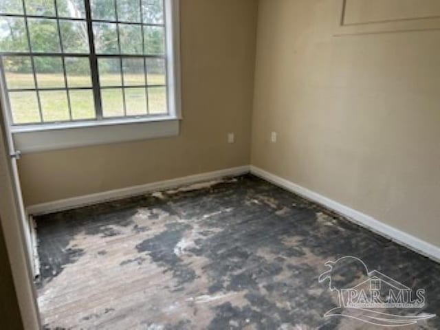 empty room featuring baseboards