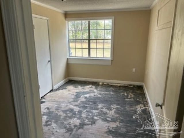 unfurnished bedroom with baseboards, ornamental molding, a textured ceiling, and carpet flooring