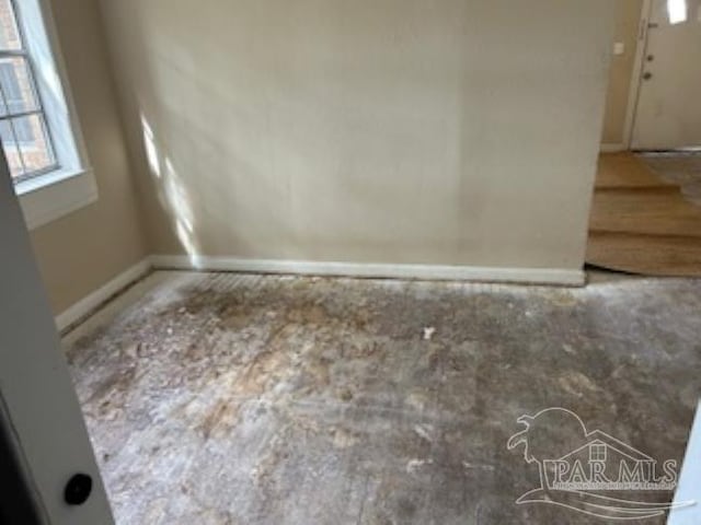 spare room with baseboards