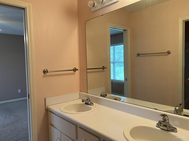 bathroom with a sink and double vanity