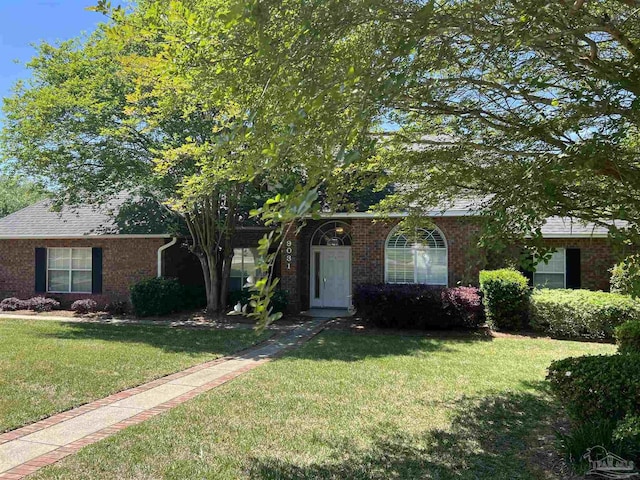view of front facade featuring a front lawn and brick siding