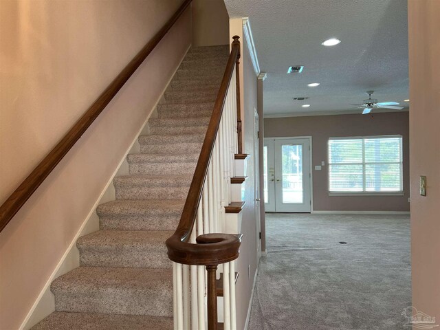 stairs with ceiling fan, a textured ceiling, carpet, recessed lighting, and baseboards