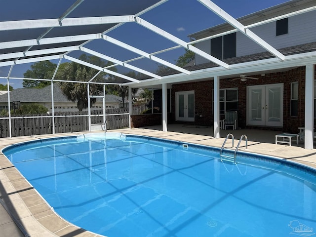 view of swimming pool with a fenced in pool, a patio area, and french doors