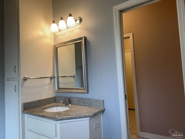 bathroom featuring tile patterned flooring and vanity