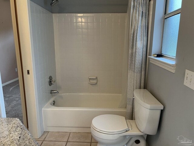 full bathroom featuring a wealth of natural light, toilet, and shower / bath combination with curtain