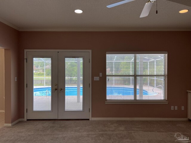 entryway featuring french doors, carpet, crown molding, and baseboards