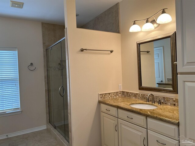 full bath featuring tile patterned floors, visible vents, a shower stall, and vanity