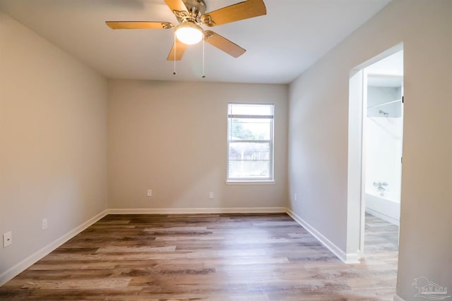 empty room featuring hardwood / wood-style flooring and ceiling fan