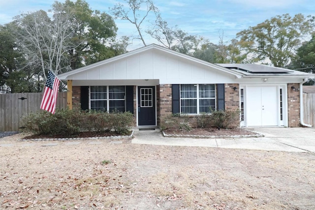 view of front of property featuring solar panels