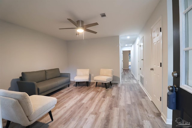 sitting room with ceiling fan and light hardwood / wood-style flooring