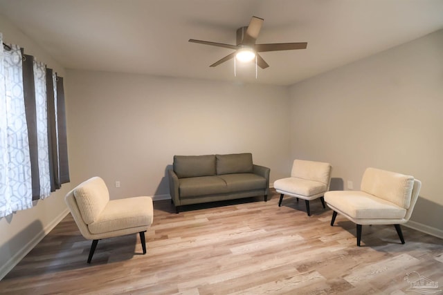 sitting room featuring ceiling fan and light wood-type flooring