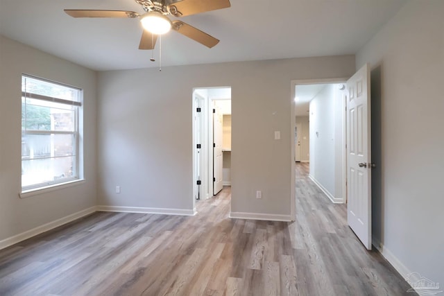 unfurnished bedroom with ceiling fan and light hardwood / wood-style flooring