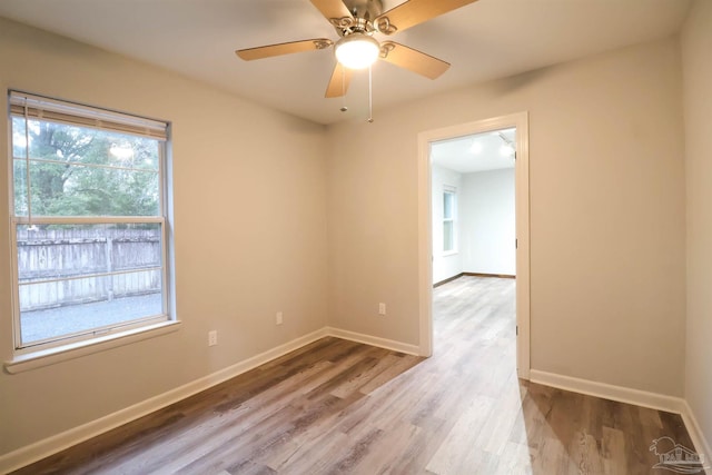 unfurnished room with hardwood / wood-style flooring and ceiling fan