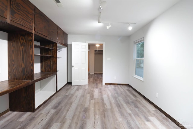 unfurnished bedroom with a closet and light wood-type flooring