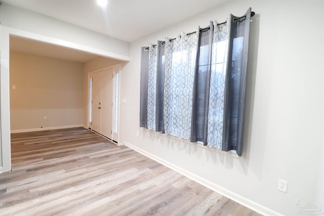 empty room with light hardwood / wood-style flooring