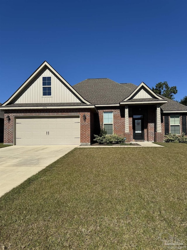 view of front of home featuring a front yard and a garage