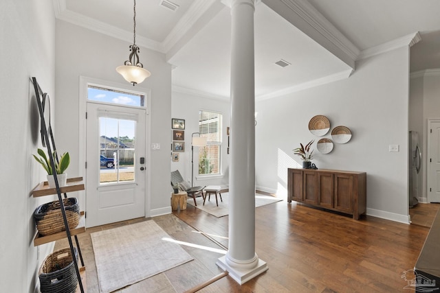 foyer entrance featuring decorative columns, crown molding, and dark hardwood / wood-style floors