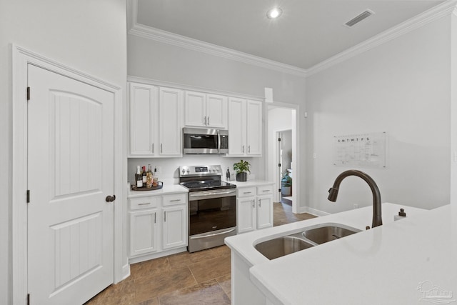 kitchen featuring white cabinetry, sink, crown molding, and appliances with stainless steel finishes