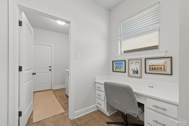 tiled office space featuring built in desk