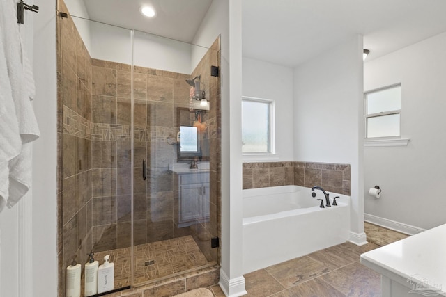 bathroom with shower with separate bathtub