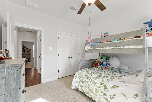 bedroom featuring ceiling fan, a closet, and light colored carpet