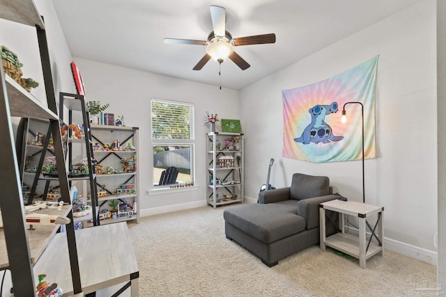 sitting room with carpet flooring and ceiling fan