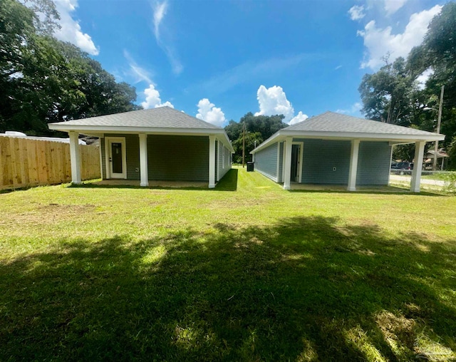 rear view of house featuring a lawn