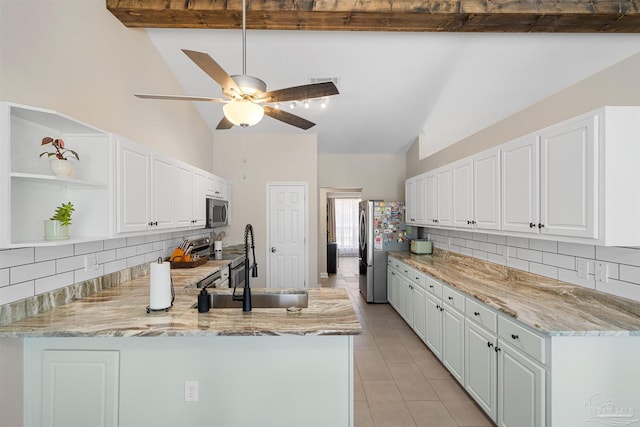 1933 Eagle Ln, Navarre, FL 32566 - kitchen featuring appliances with stainless steel finishes, a peninsula, backsplash, white cabinetry, and high vaulted ceiling