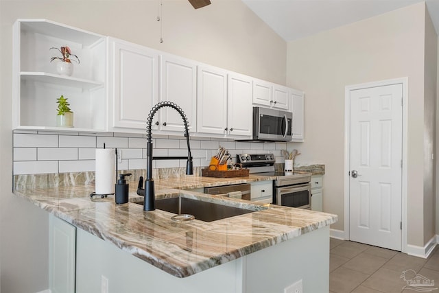 1933 Eagle Ln, Navarre, FL 32566 - kitchen with appliances with stainless steel finishes, light stone counters, backsplash, a peninsula, and white cabinets