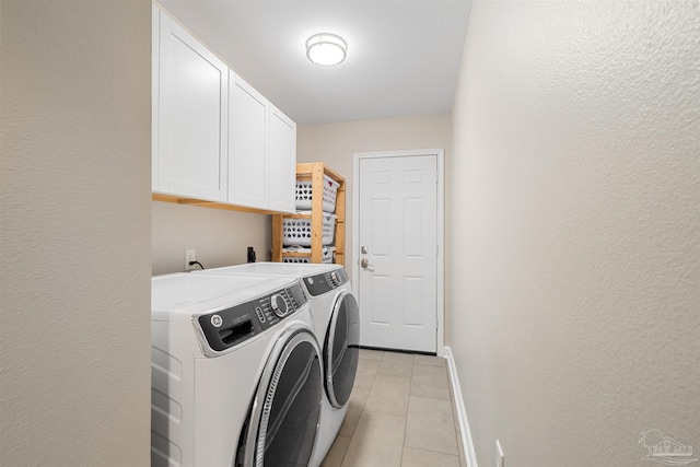 1933 Eagle Ln, Navarre, FL 32566 - washroom featuring washer and clothes dryer, light tile patterned floors, cabinet space, and a textured wall