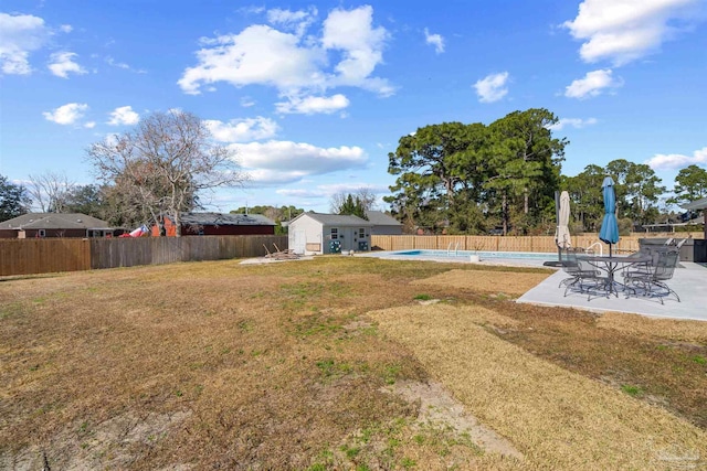 1933 Eagle Ln, Navarre, FL 32566 - fenced backyard with an outbuilding and a patio