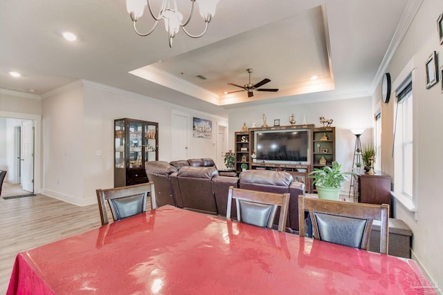 dining space with recessed lighting, wood finished floors, ornamental molding, ceiling fan with notable chandelier, and baseboards