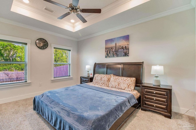 bedroom with crown molding, carpet flooring, visible vents, a raised ceiling, and baseboards