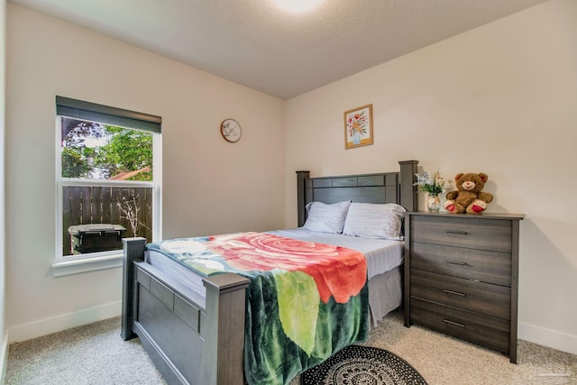bedroom with carpet floors and baseboards