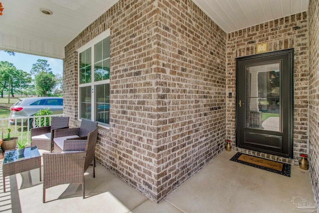 view of exterior entry with brick siding