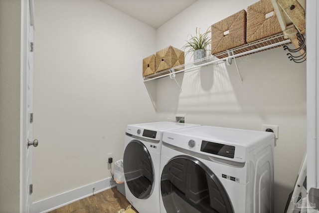 clothes washing area with wood-type flooring and washing machine and dryer