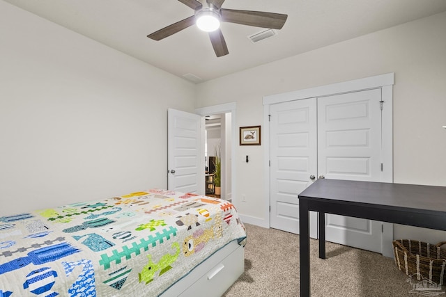 carpeted bedroom featuring ceiling fan and a closet