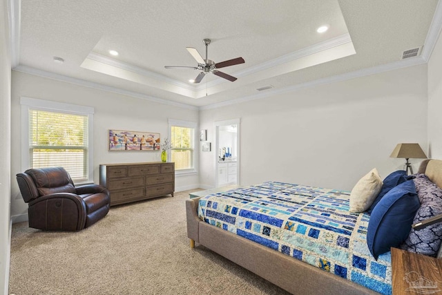 bedroom with a raised ceiling, light carpet, and multiple windows