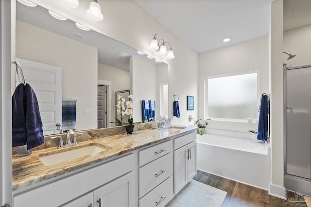 bathroom featuring vanity, wood-type flooring, and separate shower and tub