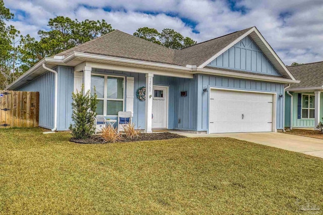 view of front of property featuring a garage and a front lawn