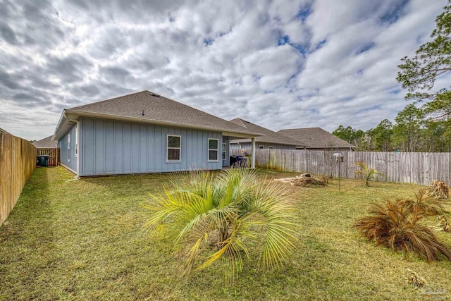 back of house with a yard