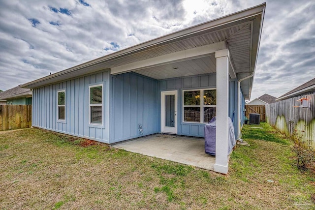 back of property with a patio, a yard, and cooling unit